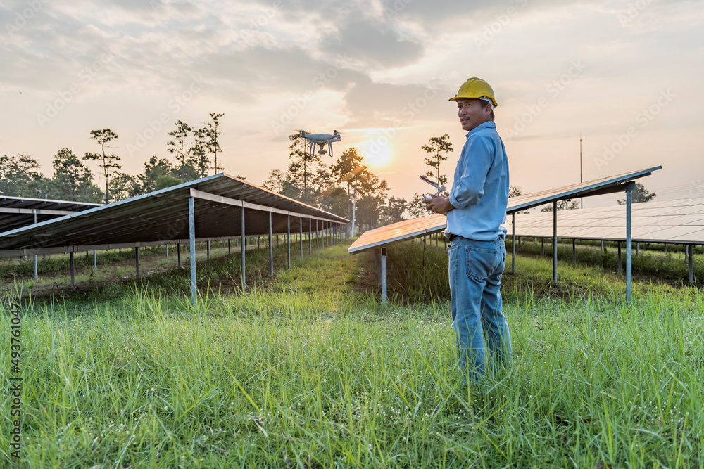 Engineers or workers People use drones to explore solar panels or solar cells on the roof of a farm. power plant with green fields renewable energy Eco-technology concept for electric power Engineers or workers People use drones to explore solar panels or solar cells on the roof of a farm. power plant with green fields renewable energy Eco-technology concept for electric power