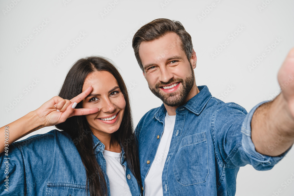 Closeup young smiling caucasian couple boyfriend and girlfriend spouses dating taking selfie photo together looking at camera, blogging vlogging for social media networks isolated in white background Closeup young smiling caucasian couple boyfriend and girlfriend spouses dating taking selfie photo together looking at camera, blogging vlogging for social media networks isolated in white background