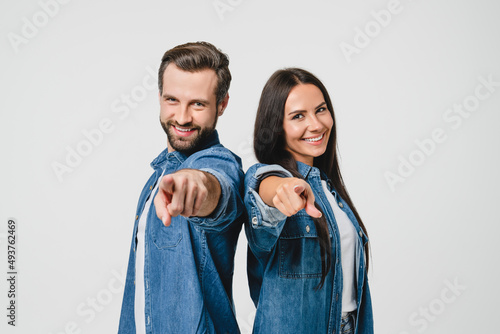 Фотография Caucasian young spouses couple pointing at camera, choosing you for new opportun