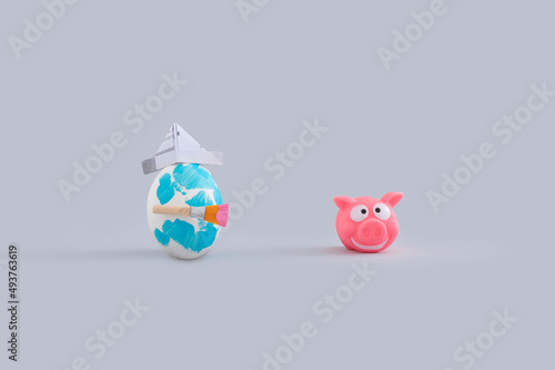 Funny Easter layout with painted egg and pig toy