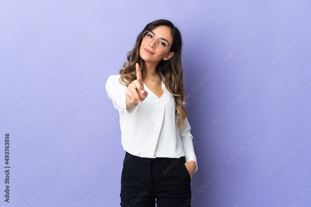 Young caucasian woman isolated on purple background showing and lifting a finger Young caucasian woman isolated on purple background showing and lifting a finger
