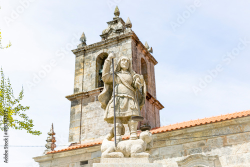statue of Saint Michael the Archangel in front of the church at Mezio village, Castro Daire, district of Viseu, Portugal photo