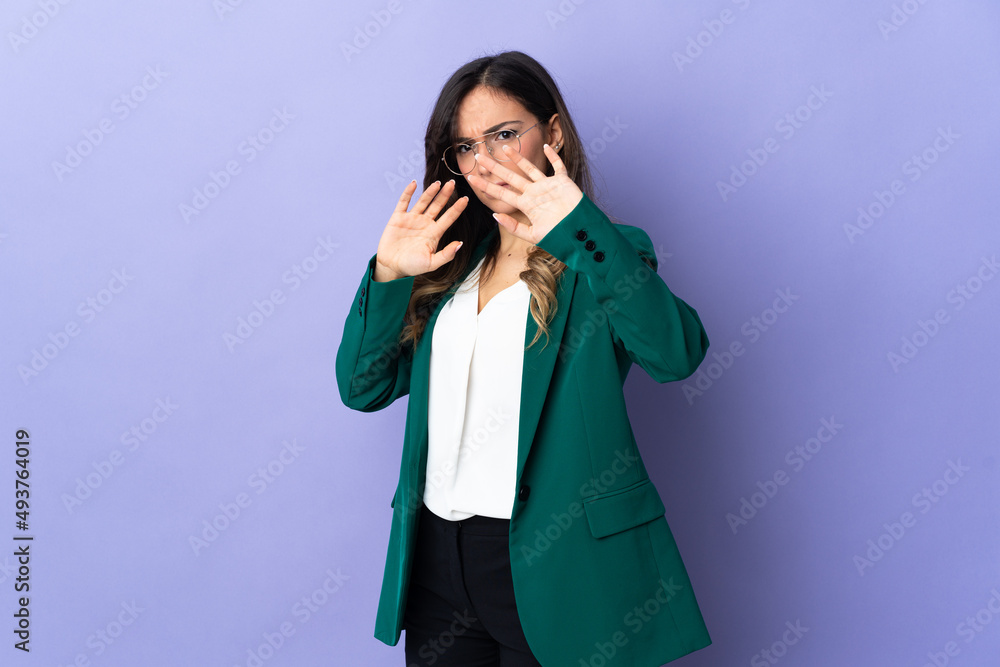 Young caucasian woman isolated on purple background nervous stretching hands to the front Young caucasian woman isolated on purple background nervous stretching hands to the front