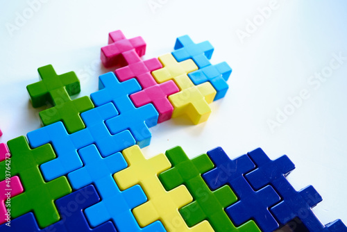 Colored puzzles on a light background. Logic games constructor for children and adults. Bright background and texture 