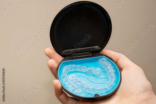 Transparent aligners and storage case. Invisible braces. Clear teeth straighteners. Plastic bracers photo