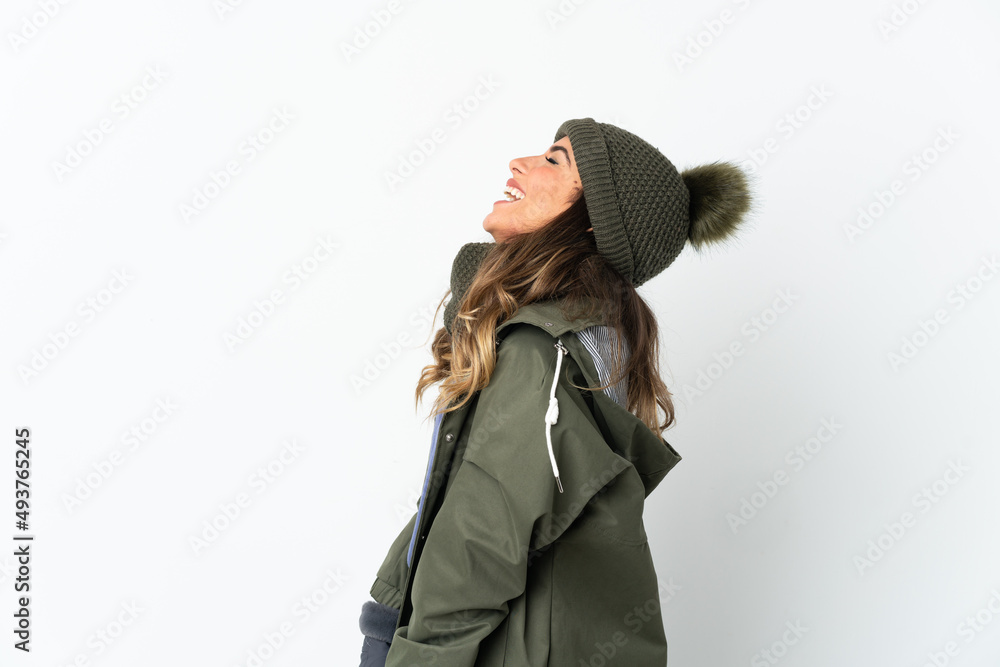 Young girl with winter hat isolated on white background laughing in lateral position Young girl with winter hat isolated on white background laughing in lateral position
