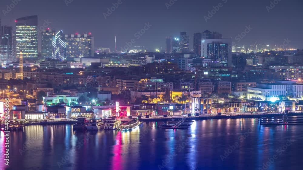 Dubai creek landscape night timelapse with boats and ship near waterfront Dubai creek landscape night timelapse with boats and ship near waterfront