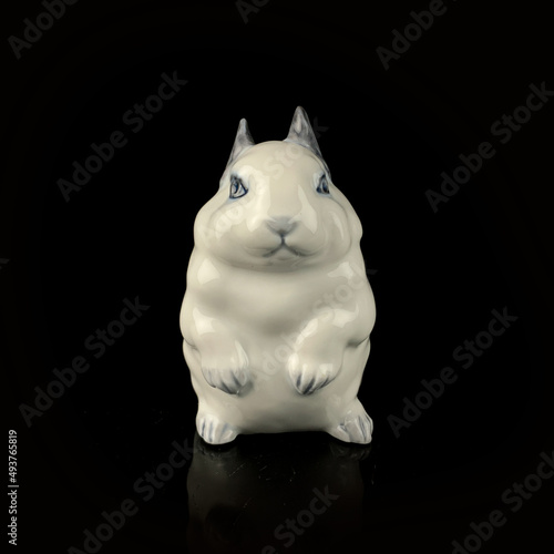 antique figurine of an easter bunny on a black isolated background