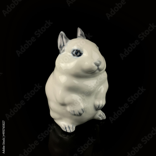 antique figurine of an easter bunny on a black isolated background