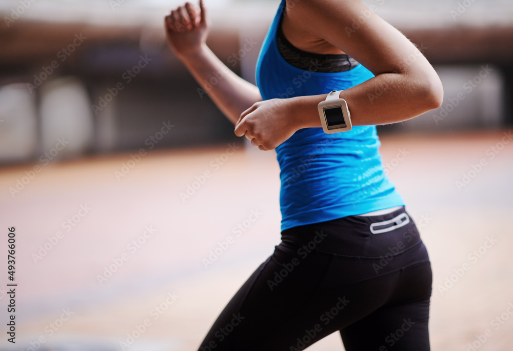 Fototapeta premium Staying fit thanks to a daily run. Cropped shot of a young woman out running.