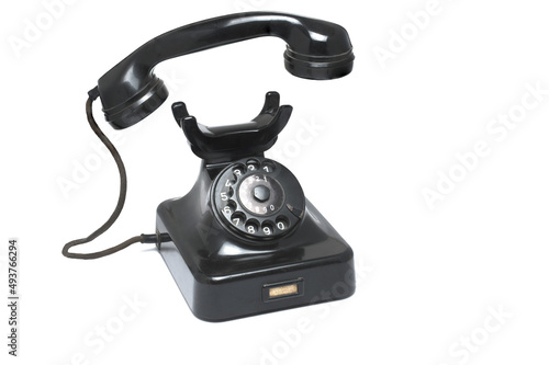 Closeup black retro phone earpiece cable white background