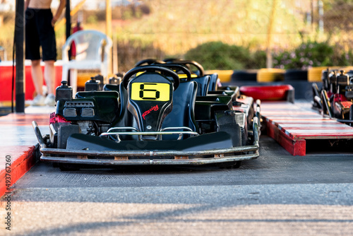 Black kart with number 6 on a parking place. Ready to be used. © Maksym