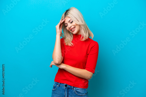 Young Russian woman isolated on blue background laughing