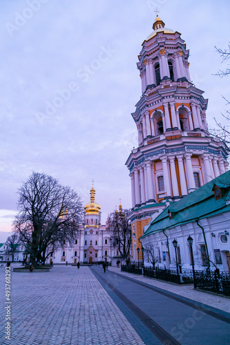 Medieval Gate Church of the Trinity of Kyiv Pechersk Lavra. View of east facade from the monastery side on a background of blue sky with clouds in winter. 