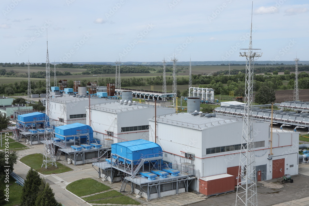 Fototapeta premium Gas transportation system. Booster pumping station for gas. Gas filling station and gas tanks. Transportation of gas around the world. Oil and gas sector. Gas turbines.