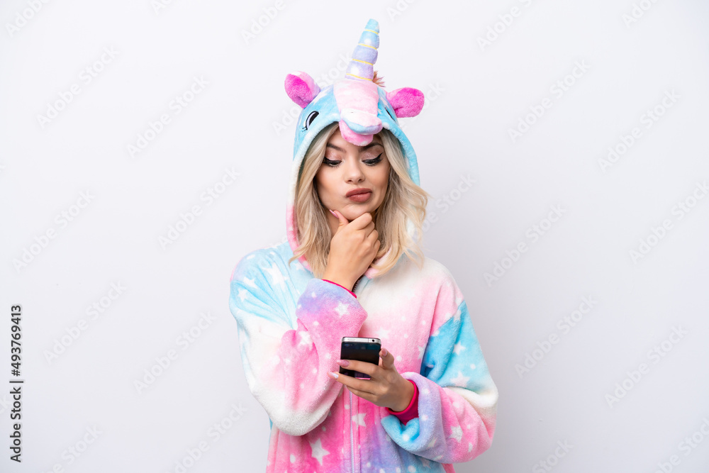 Young Russian woman with unicorn pajamas isolated on white background thinking and sending a message Young Russian woman with unicorn pajamas isolated on white background thinking and sending a message