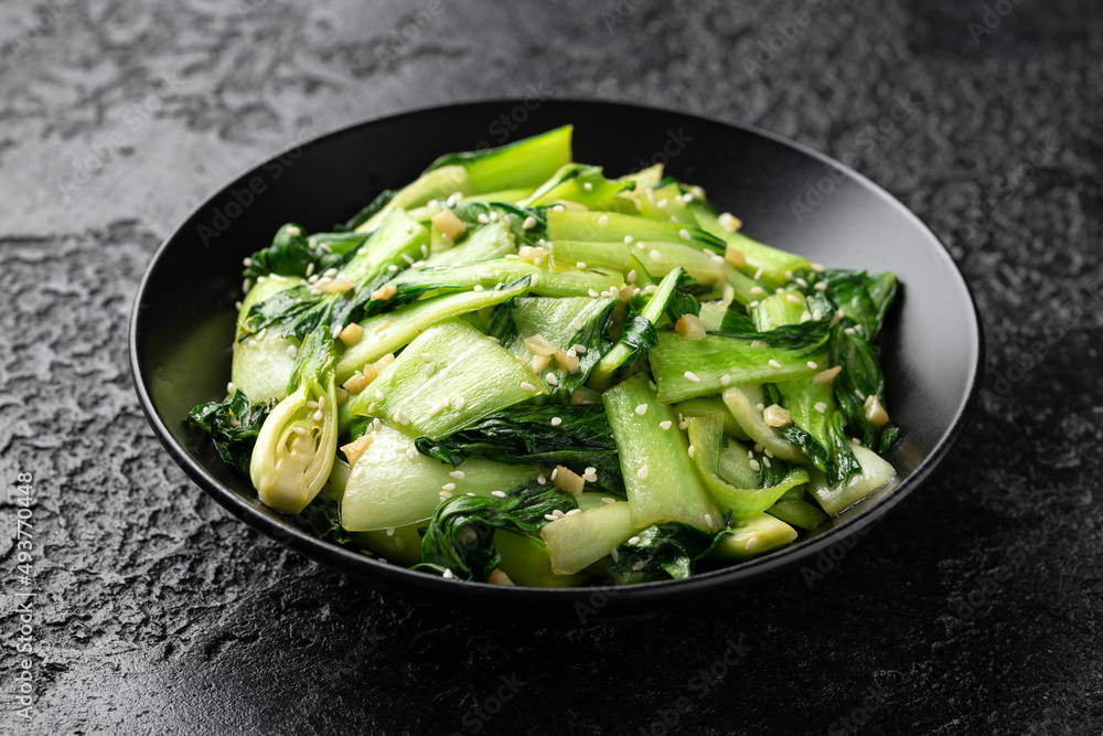 Chinese fried Pak Choi with garlic, sesame seeds. Healthy food