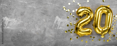 Konstfotografi Yellow foil balloon number, number twenty on a concrete background
