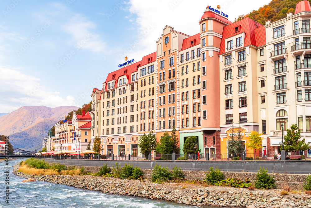 Colorful houses on the embankment in the Rosa Khutor resort.