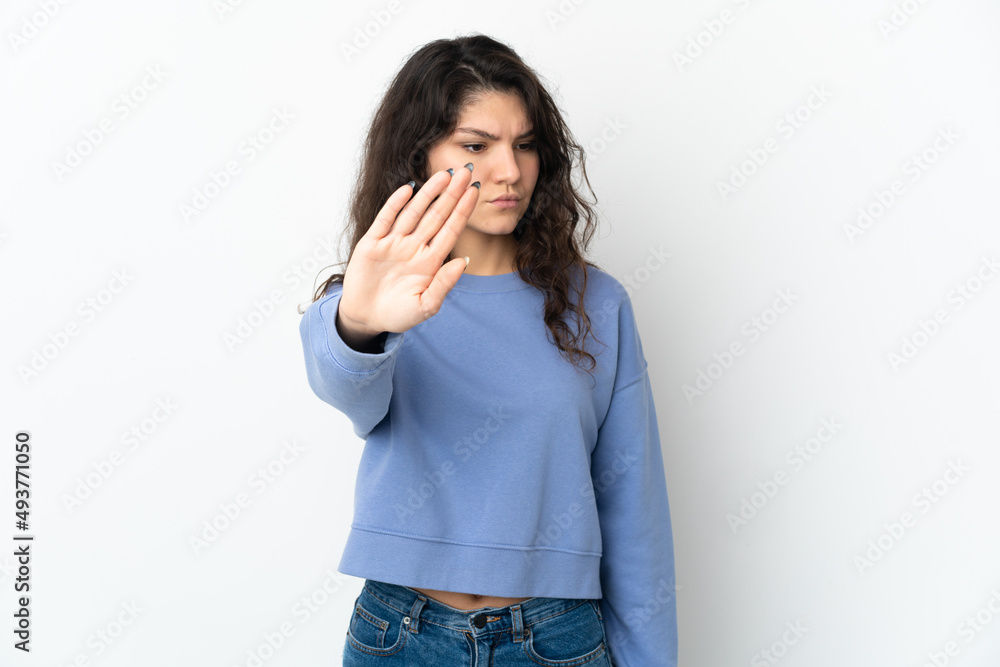 Teenager Russian girl isolated on white background making stop gesture and disappointed Teenager Russian girl isolated on white background making stop gesture and disappointed