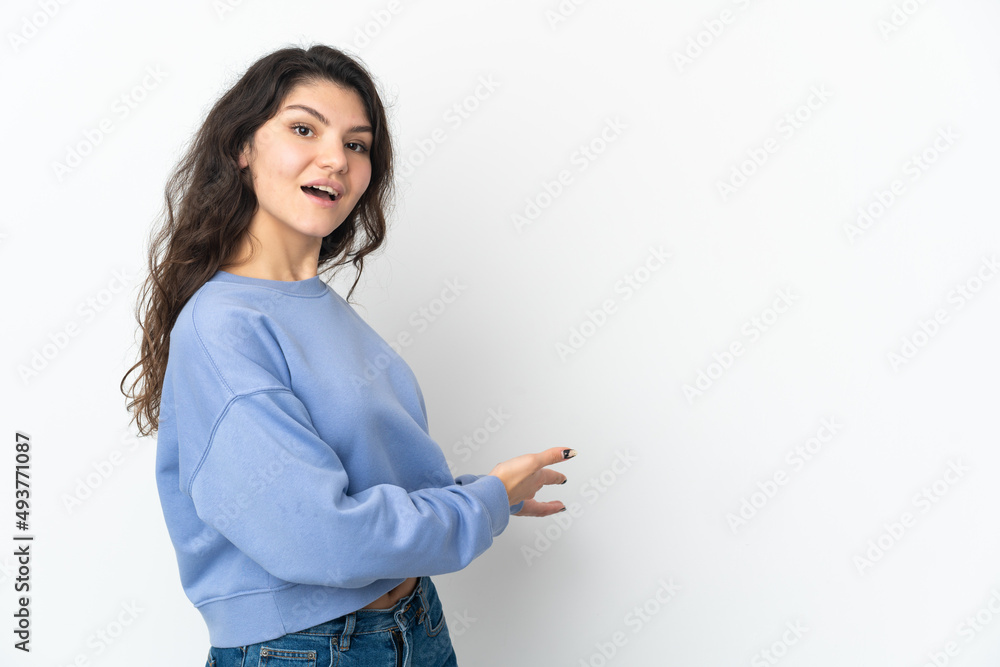 Teenager Russian girl isolated on white background extending hands to the side for inviting to come Teenager Russian girl isolated on white background extending hands to the side for inviting to come