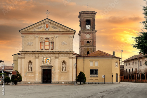 Cavallerleone, Cuneo, Italy - March 16, 2022: The parish church of Santa Maria Assunta and of Misericordia (17th century) in Santa Maria square with colorful sunset sky