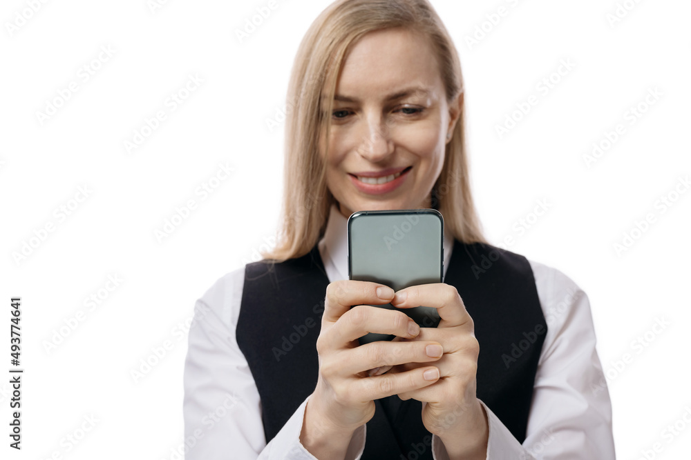 Caucasian business woman in formal wear texting on modern smartphone over white studio background. Technology and people concept. Caucasian business woman in formal wear texting on modern smartphone over white studio background. Technology and people concept.