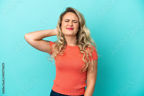 Young Brazilian woman isolated on blue background with neckache © luismolinero