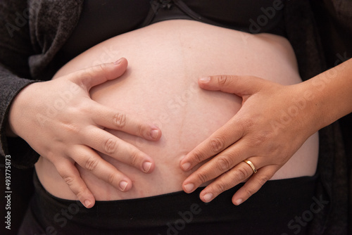 Belly of a pregnant woman , Woman with red nail polish, shadow on a woman's belly, shadow on a pregnant woman's belly, Young pregnant woman , Detail of a pregnant woman , Pregnancy concept , belly