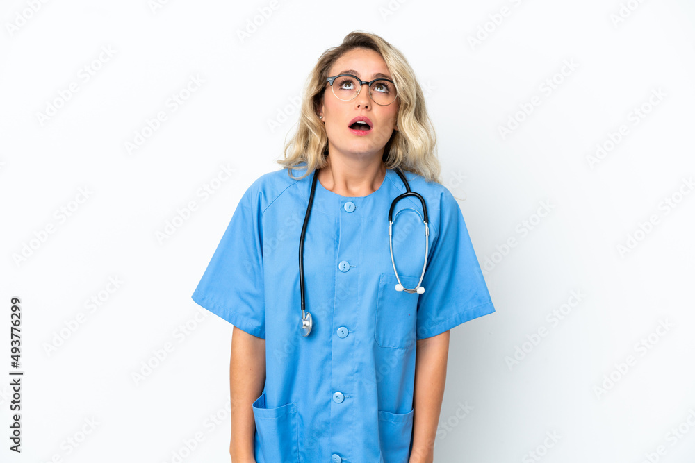 Brazilian surgeon doctor woman over isolated background looking up and with surprised expression Brazilian surgeon doctor woman over isolated background looking up and with surprised expression
