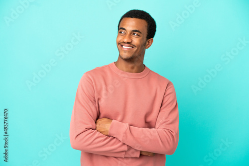 African American handsome man on isolated blue background thinking an idea while looking up