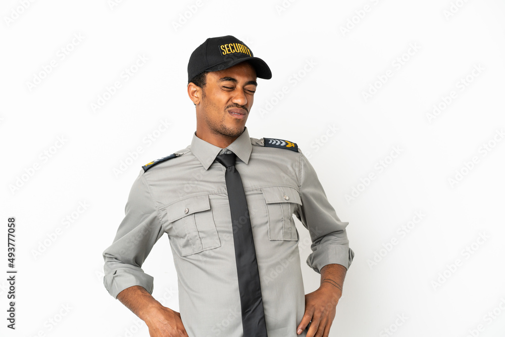 African American safeguard over isolated white background suffering from backache for having made an effort African American safeguard over isolated white background suffering from backache for having made an effort
