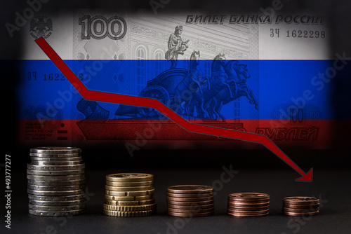 Default in Russia. The arrow calls down against the background of Russian money. Crisis in the country because of the war. Graphic of falling ruble