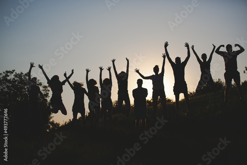 silhouettes of cheerful people jumping. team celebrating happy jumping 
