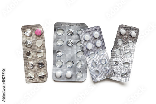 Several used blister packs with tablets, on a white background photo