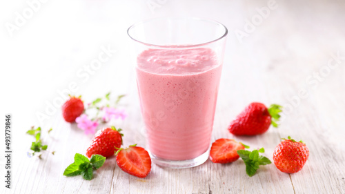 strawberry smoothie in glass with strawberries
