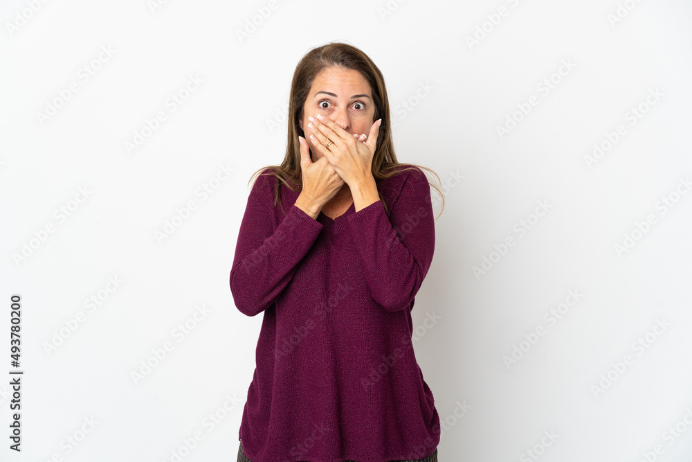 Middle age Brazilian woman isolated on white background covering mouth with hands Middle age Brazilian woman isolated on white background covering mouth with hands