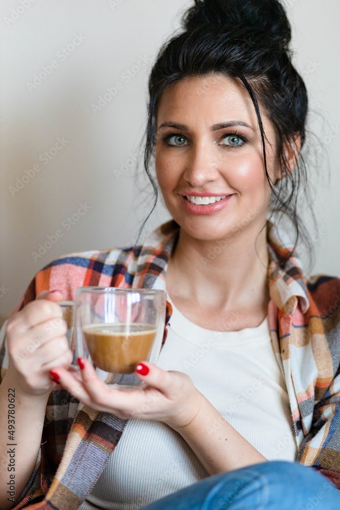 Blue eyed middle aged woman sitting with a cup of coffee Blue eyed middle aged woman sitting with a cup of coffee