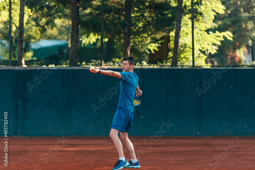 Professional equipped male tennis player beating hard the tennis ball with a forehand © qunica.com