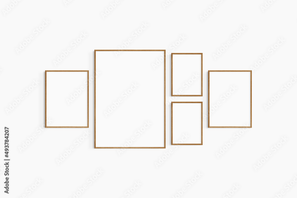 Gallery wall mockup. Set of 5 cherry wood frames. Gallery wall frame mockup. One 50x70 (5:7), two 30x40 (3:4), and two A4 (5:7) wooden frames. Gallery wall mockup. Set of 5 cherry wood frames. Gallery wall frame mockup. One 50x70 (5:7), two 30x40 (3:4), and two A4 (5:7) wooden frames.