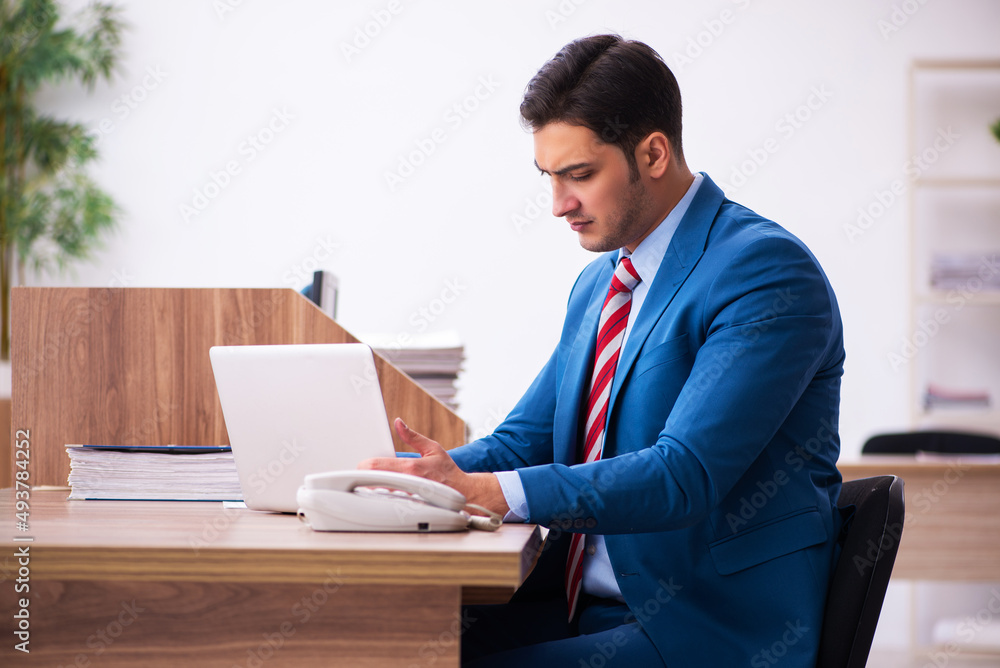 Young businessman employee working in the office Young businessman employee working in the office