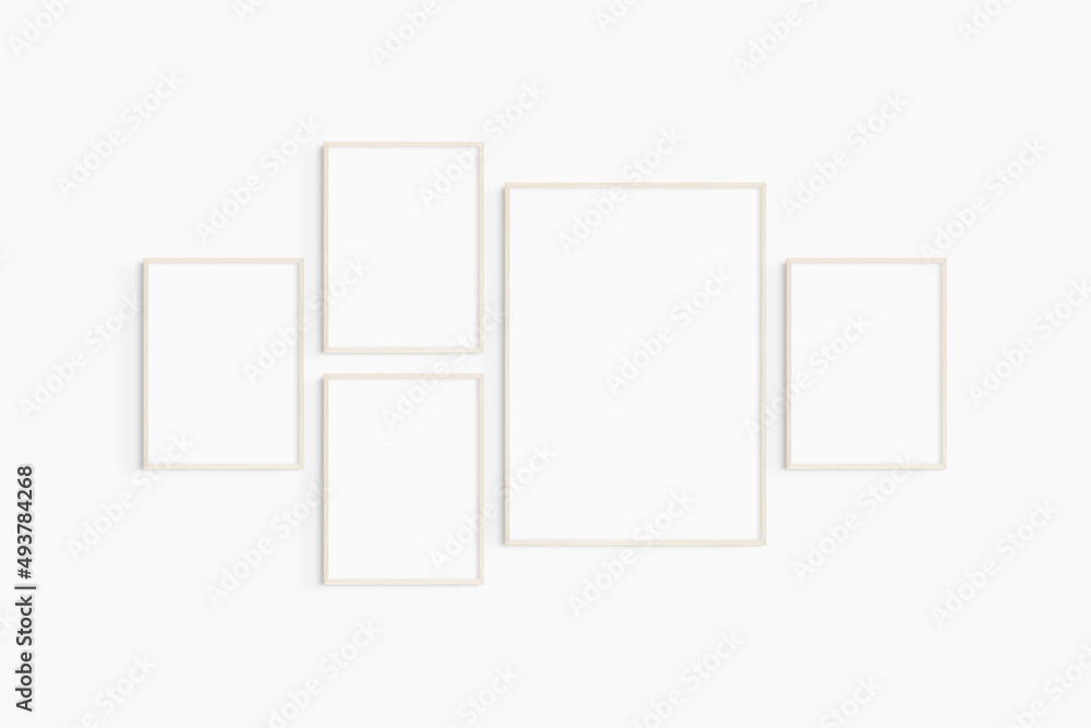 Gallery wall mockup. Set of 5 light wood frames. Gallery wall frame mockup. One 50x70 (5:7) and four 30x40 (3:4) wooden frames. Gallery wall mockup. Set of 5 light wood frames. Gallery wall frame mockup. One 50x70 (5:7) and four 30x40 (3:4) wooden frames.