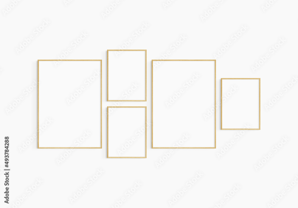 Gallery wall mockup. Set of 5 oak wood frames. Gallery wall frame mockup. Two 50x70 (5:7) and three 30x40 (3:4) wooden frames. Gallery wall mockup. Set of 5 oak wood frames. Gallery wall frame mockup. Two 50x70 (5:7) and three 30x40 (3:4) wooden frames.