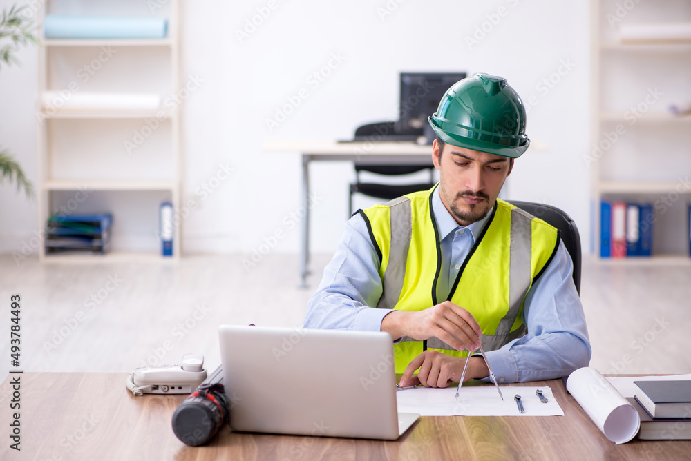 Young male architect working in the office Young male architect working in the office