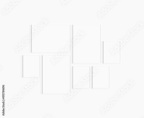 Gallery wall mockup. Set of 7 white frames. Gallery wall frame mockup. Two 50x70 (5:7), one 70x50 (7:5), and four 30x40 (3:4) white frames.