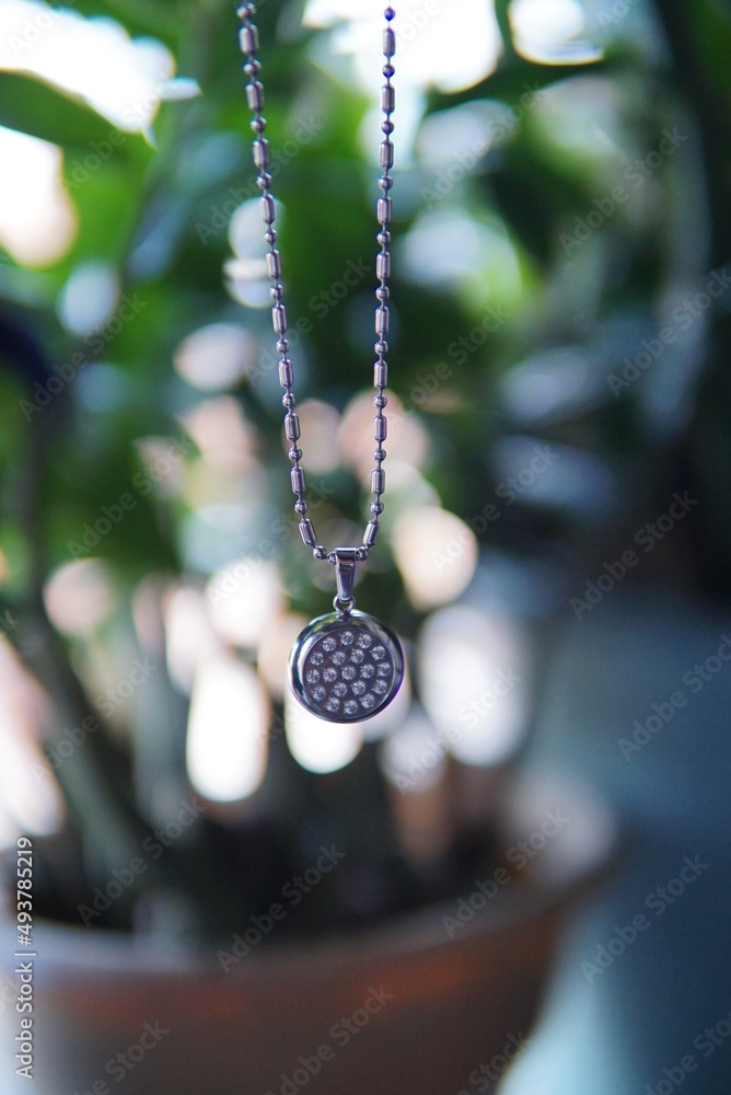 stone pendants and silver and gold ornaments. Jewelry on natural backdrop. vintage necklace with nature background.