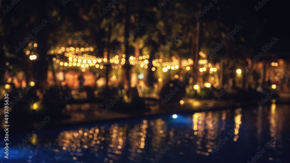 Blurred wedding party in outdoor garden by the pool