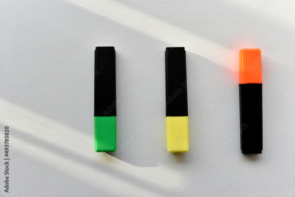 Fototapeta premium Colored markers on a white background in the light
