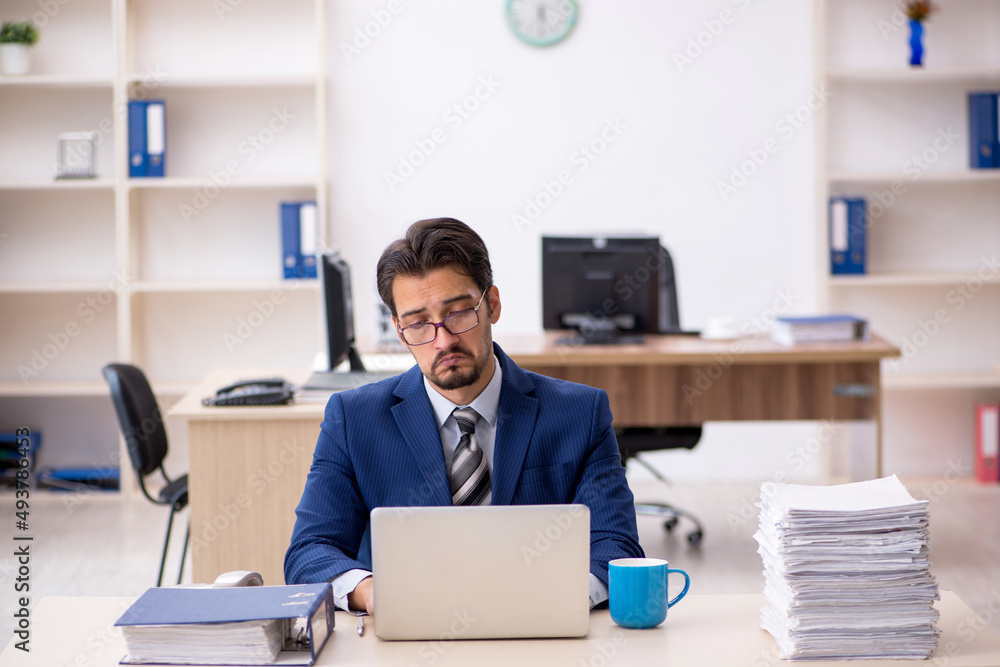 Young male employee working in the office Young male employee working in the office