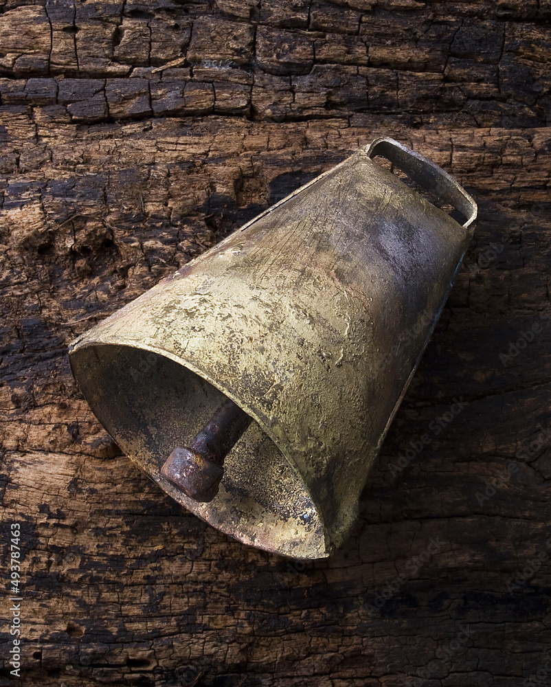 Brazilian rustic rattle, made of metal for use in cattle, photographed on old wood. Brazilian rustic rattle, made of metal for use in cattle, photographed on old wood.